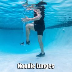 a woman in black shirt and shorts under water with noodle lunges on her feet