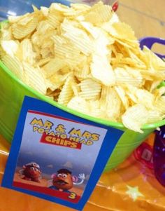 a green bowl filled with chips on top of a table