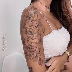 a woman with a rose tattoo on her arm