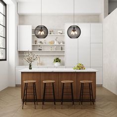 a kitchen with three stools in front of the counter and two hanging lights above it