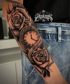 a man's arm with a clock and roses on it