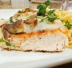 a white plate topped with meat and pasta