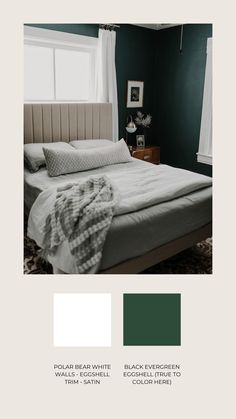 a bedroom with dark green walls and white bedding