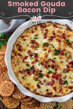 the baked goula bacon dip in a white dish with crackers