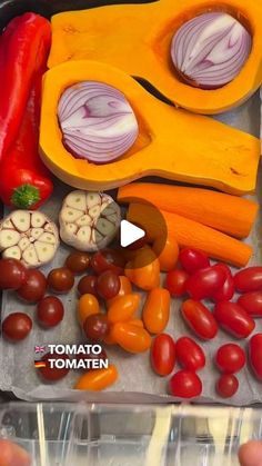 tomatoes, onions, carrots, and other vegetables are arranged on a plastic tray