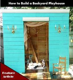 a small blue shed with a dog sitting in the doorway and chairs around it outside