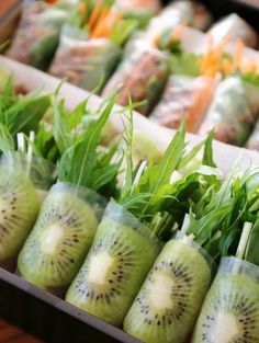 many different fruits and vegetables are arranged in the shape of kiwis on display