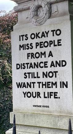 a monument with a quote on it that says, it's okay to miss people from a distance and still not want them in your life