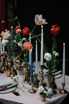 a table topped with lots of candles and flowers