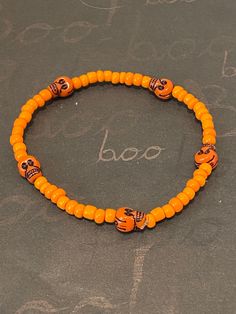 This is a skull beaded bracelet.  It would make a great addition to your Halloween costume. It would make a spooky gift for a teen for Halloween. It has five orange skull beads. It has orange seed beads. It was made with .8mm sturdy stretch string. I tie it several times to prevent breakage. It fits most teens and women. It stretches to fit on the wrist. All items are ready to be shipped I do combined shipping. Items ship in 2-5 business days. Check out more items at: http://www.etsy.com/shop/Me Novelty Orange Bracelets For Halloween, Halloween Novelty Orange Bracelets, Handmade Halloween Festival Bracelets, Handmade Halloween Festival Bracelet, Halloween Novelty Beaded Bracelets With Round Beads, Novelty Beaded Bracelets For Halloween, Halloween Bracelets With Letter Beads And Round Shape, Halloween Novelty Bracelet With Round Beads, Halloween Letter Beads Bracelet With Round Beads