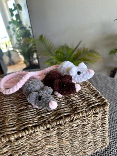 three stuffed animals are sitting in a basket