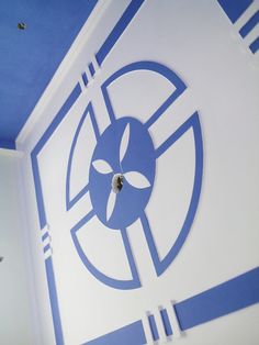 a blue and white room with a clock on the ceiling