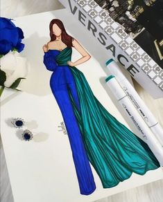 a drawing of a woman in a blue dress next to a pen and flower on a table