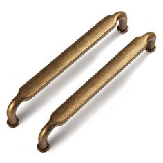 two antique brass handles on a white background