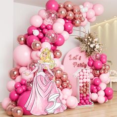 there is a pink princess balloon arch with balloons on the wall and decorations around it