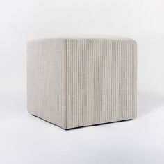 a square stool made out of fabric on a white background with no people around it