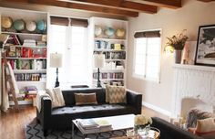 a living room filled with furniture and bookshelves next to a fire place in front of a fireplace