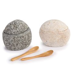 three different types of rocks and wooden spoons