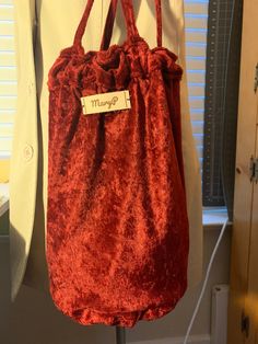 a red bag hanging on a clothes rack