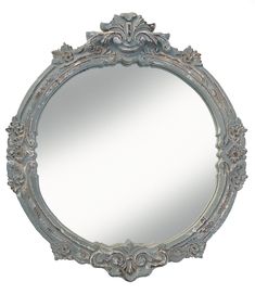 an ornate mirror is shown against a white background