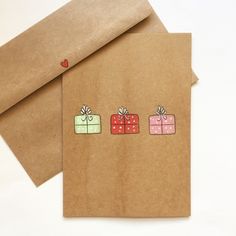 two brown envelopes with gift boxes drawn on them