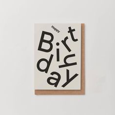 a greeting card with the words happy birthday written in black on it, against a white background