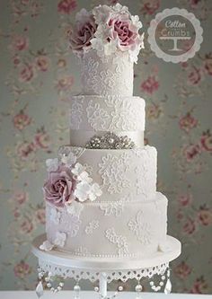 a white wedding cake with pink flowers on top