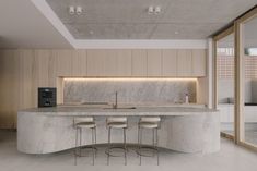 a kitchen with marble counter tops and stools