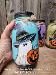 painted mason jars with pumpkins and witches on them