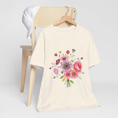 This tee features a printed, cross-stitch-inspired bouquet.  This classic unisex jersey short sleeve tee fits like a well-loved favorite. Soft cotton and quality print make users fall in love with it over and over again. These t-shirts have-ribbed knit collars to bolster shaping. The shoulders are tapered for a better fit over time. Dual side seams hold the garment's shape for longer. .: Made with 100% Airlume combed and ring-spun cotton, a lightweight fabric (4.2 oz/yd² (142 g/m that is easy to layer, breathable. Perfect for active and leisure wear.  .: The retail fit that is perfect for casual and semi-formal settings. The crew neckline adds a classic, neat style that's perfect for accessorizing. .: Bella+Canvas manufactures all its products in the US and internationally in humane, no-sw Prism Color, Leisure Wear, Lightweight Fabric, Jersey Shorts, Semi Formal, Fall In Love, Ribbed Knit, Short Sleeve Tee, Print Quality