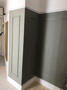 an empty room with gray walls and white trim