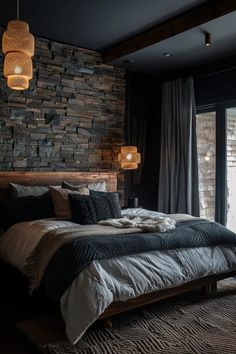 a bedroom with stone wall and wooden headboard in the corner, along with large windows