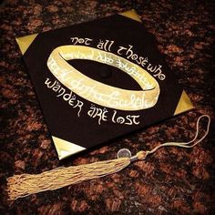 a black and gold graduation cap with writing on it