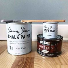 two cans of chalk paint and a wooden stick