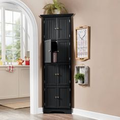 a tall black cabinet in the corner of a room