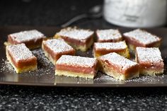 several pieces of cake on a plate with powdered sugar