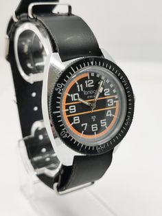 Magnificent 1970s retro vintage French diver watch Tanagra, beautiful black orange dial with arabic numerals, very vivid colors. Manual winding mechanical movement 17 rubis, keeps brilliant time for its age. Glass was replaced. In very good in working condition, comes with black synthetic leather nato strap, huge wrist presence, rare vintage version, worth collecting. Movement: Manual winding Movement/Caliber: MECHANICAL Number of jewels: 17 Case material: Steel Case diameter: 37 x 42 mm Thickne 1970s Bands, Pocket Compass, Diver Watch, Mens Chronograph, Compass Pendant, Amazing Watches, Nato Strap, Old Watches, Mechanical Movement