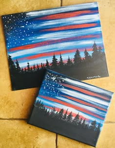 two canvases painted to look like night sky with stars and trees in the background