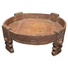 an old wooden table with carvings on it