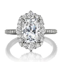 an engagement ring with a cushion cut diamond surrounded by diamonds