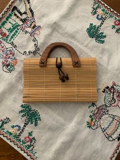 Bamboo bag with toggle closure and wood handles.  Cloth lined.  Excellent condition. Vintage Natural Satchel For Daily Use, Daily Use Rectangular Satchel With Bamboo Handle, Everyday Rectangular Bag With Bamboo Handle, Vintage Natural Shoulder Bag, Retro Rectangular Natural Bag, Everyday Brown Satchel With Bamboo Handle, Natural Satchel With Bamboo Handle For Daily Use, Natural Satchel With Bamboo Handle Tote, Natural Tote Satchel With Bamboo Handle