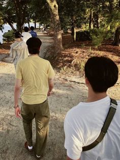 several people walking down a path in the woods