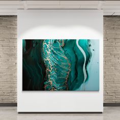 an abstract painting hangs on the wall next to a white brick wall in a room