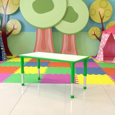 a child's playroom with colorful carpet, trees and tent in the background