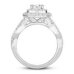 a white gold engagement ring with three stone halos