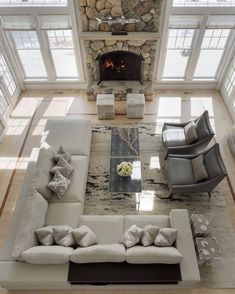 an aerial view of a living room with couches, chairs and a fire place