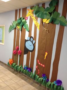 this is an image of a classroom wall decorated with paper jungle animals and giraffes