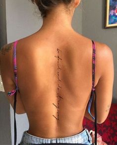 the back of a woman's body with writing on her upper back and lower back