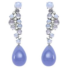 Alex Jona design collection, hand crafted in Italy, 18 karat white gold pair of drop earrings, featuring moonstone and chalcedony cabochons, 0.66 carats of white diamonds and a pair of pear shaped Namibian Chalcedony cabochon drops, weighing 50.89 carats in total. Dimensions: W x 13mm, D x 13mm, H x 59mm / W x 0.51 in, D x 0.51 in, H x 2.32 in. Alex Jona jewels stand out, not only for their special design and for the excellent quality of the gemstones, but also for the careful attention given to White Gold Drop Earrings, Chalcedony Earrings, Fabulous Jewelry, Blue Chalcedony, Lovely Jewellery, Design Collection, Gold Drop Earrings, White Diamonds, Special Design