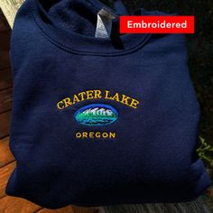 *SIZES ARE UNISEX* -I'd suggest your usual size for a more fitted look, or sizing up for a more relaxed fit. *these sweatshirts are extra comfy when oversized 🏔 "Crater Lake Oregon" embroidered on a comfy cute vintage-style crewneck. A sturdy and warm sweatshirt bound to keep you warm in the colder months. A pre-shrunk, classic fit sweater that's made with air-jet spun yarn for a soft feel and reduced pilling. Your new favorite sweatshirt! * 50% cotton, 50% polyester * Pre-shrunk * Classic fit Winter Crew Sweats With Embroidered Logo, Casual Embroidered Crew Neck Hoodie, Fall Crew Sweats With Embroidered Logo, Custom Embroidered Crew Neck Hoodie For College, Casual Crew Neck Hoodie With Embroidered Graphics, Casual Hoodie With Embroidered Graphics And Crew Neck, Casual Embroidered Crew Sweater, Casual Embroidered Crew Neck Sweater, Casual Crew Neck Embroidered Sweater